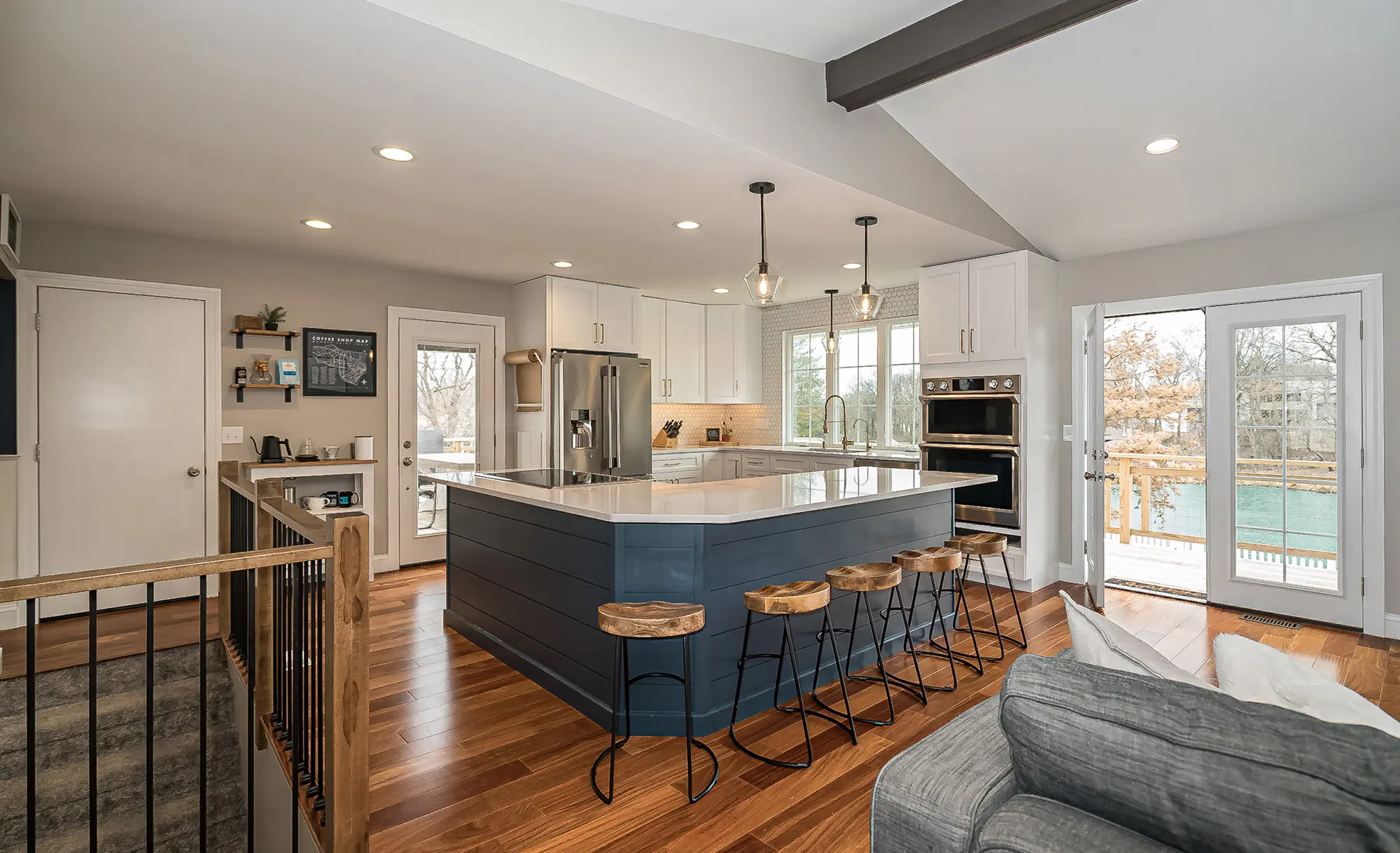Kitchen of a completed new-construction home, with island seating and a vaulted ceiling
